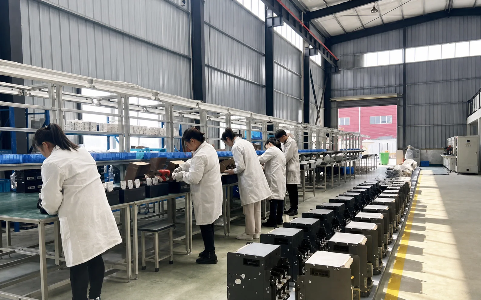 Workers assembling electrical components at the HJATIS factory in Pingxiang