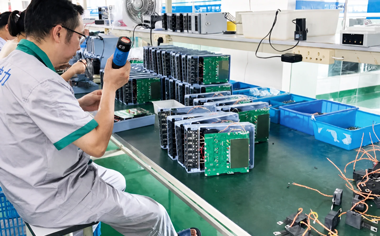 Technician inspecting electrical metering and protection devices at HJATIS