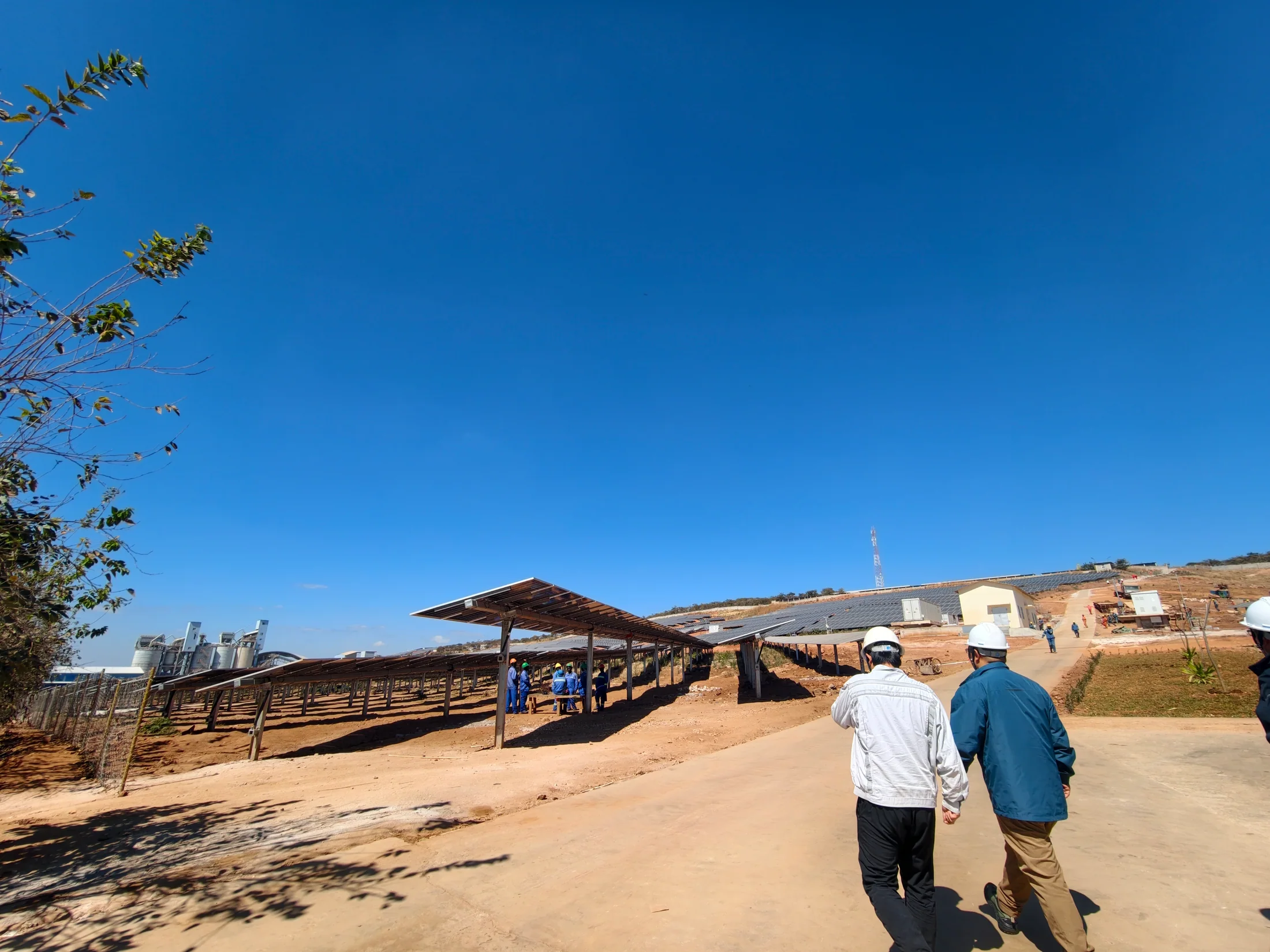 HJATIS engineers walking through a solar project site